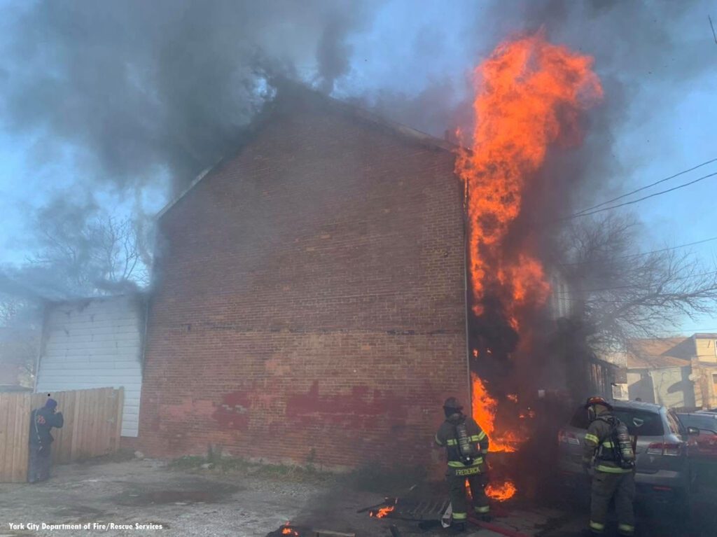 Firefighters outside a burning building